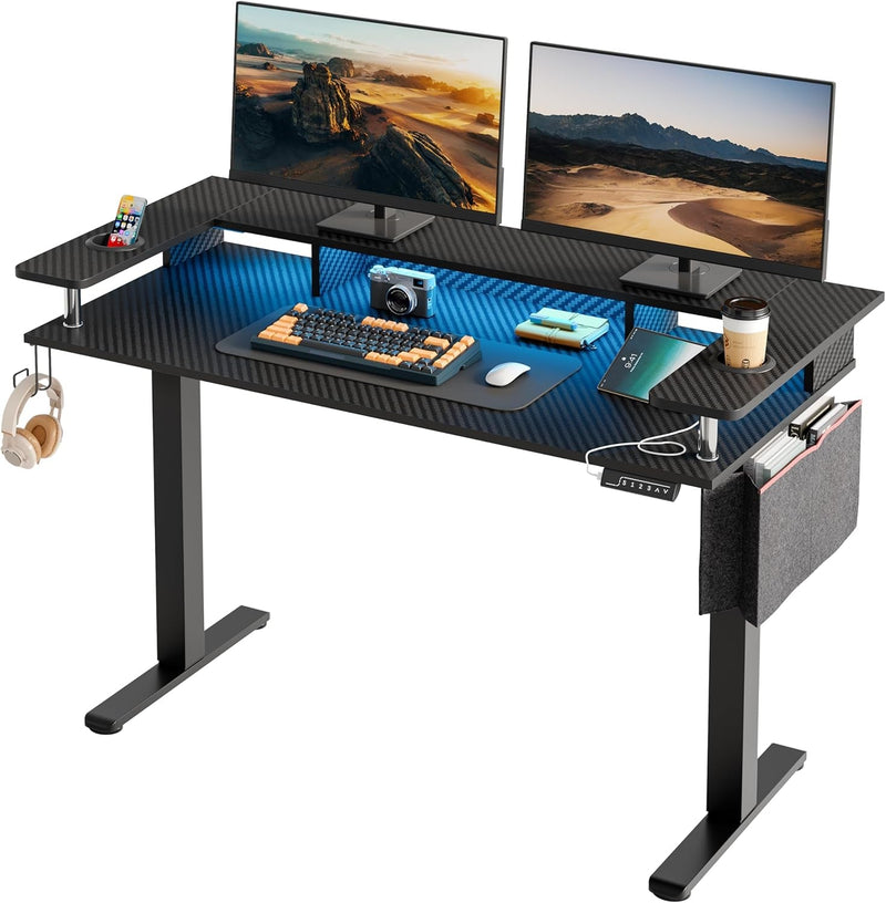 Bestier LED Electric Standing Desk Adjustable Height, 58X26 Inch Large Sit Stand Desk with Monitor Stand, Ergonomic Rising Office Desk with Headphone Hook & Storage Bag, 3D Carbon Fiber