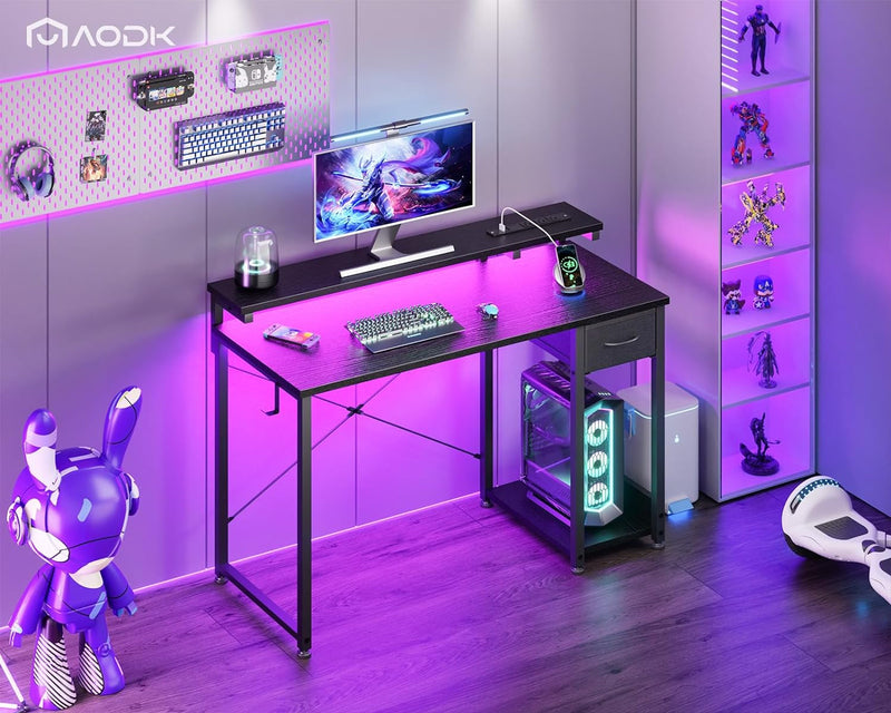 AODK Gaming Desk with LED Lights & Power Outlet, 40 Inch Computer Desk with Drawer, Reversible Desk with Adjustable Monitor Shelf & Headphone Hook for Home Office, Black
