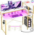 Bureau de jeu Cylysio 39", bureau d'ordinateur avec étagères de rangement réversibles, bureau à domicile avec prises de courant et lumières LED RVB, petit bureau pour jouer, étudier, travailler, noir