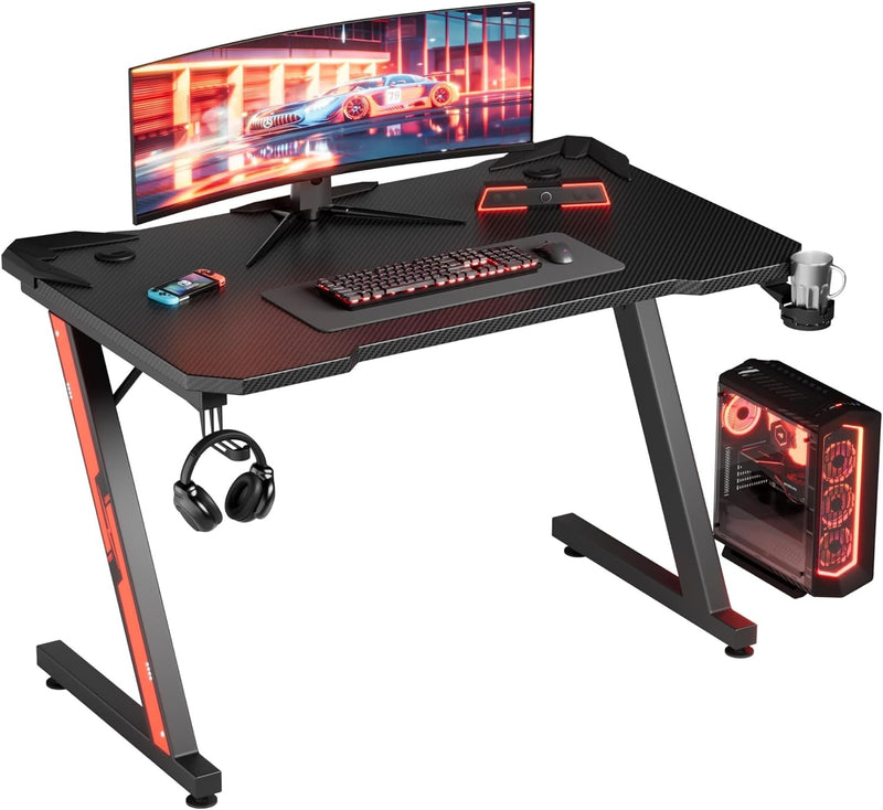 Furmax Gaming Desk Computer Desk Z-Shaped Gaming Table with Carbon Fibre Surface Home Office Desk PC Workstation Desk with Cup Holder, Headphone Hook Modern Style Desk (Black, 44 Inch)